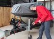 Man hitching his boat to his trailer in his garage