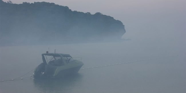 power boat on the water in heavy fog