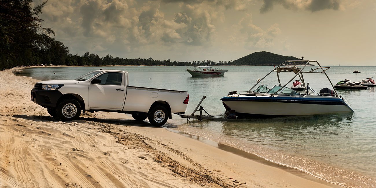 A truck releasing a boat into the water